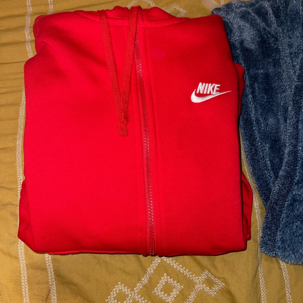 Red zip up hoodie. Size small in men’s. I took off the tag but never wore it.